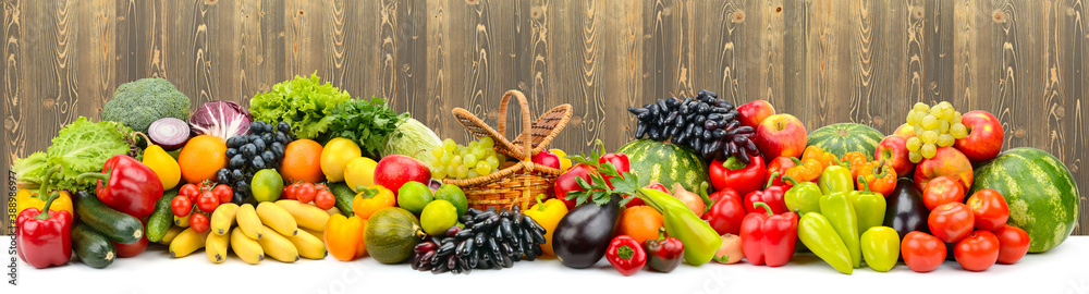 Panoramic collage juicy fruits, berries and vegetables on wooden background.