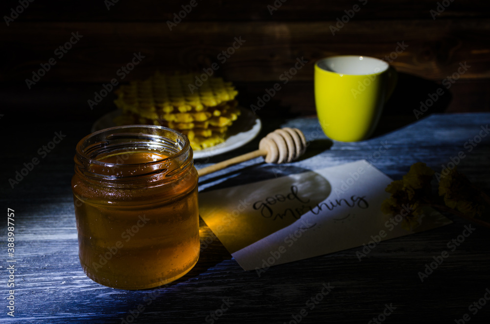 Still life with cup of coffee and waffles on the wooden background. Photo taken in low light key. Still life with cup of coffee and waffles on the wooden background. Photo taken in low light key.