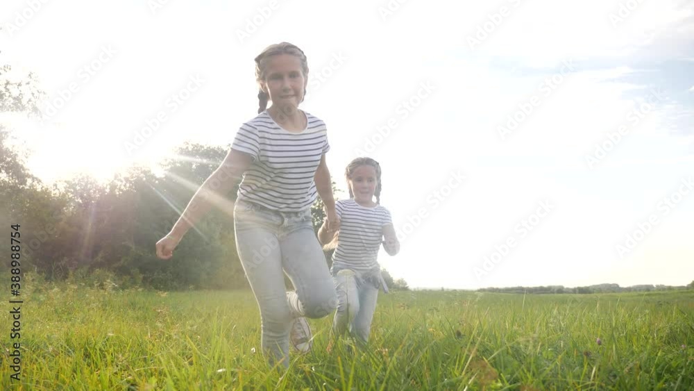happy family children kid together run in the park at sunset. people in the park concept. two sisters joyful run. happy family and little baby lifestyle child fun summer kid dream concept happy family children kid together run in the park at sunset. people in the park concept. two sisters joyful run. happy family and little baby lifestyle child fun summer kid dream concept