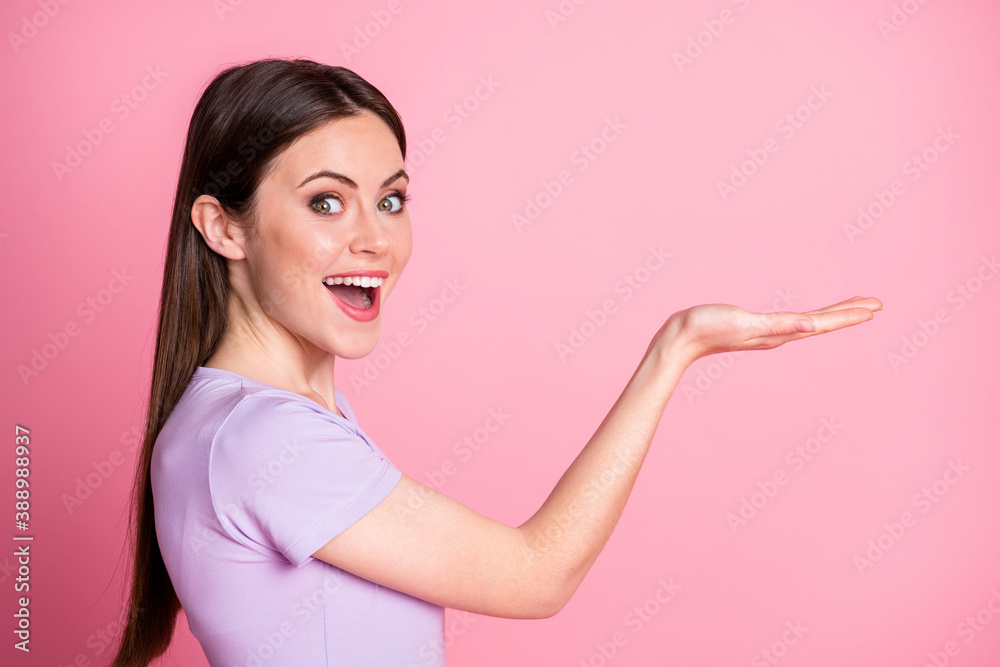 Profile photo of attractive funny excited lady hold open arm palm showing new product sale discount shopping low price wear casual purple t-shirt isolated pink pastel color background Profile photo of attractive funny excited lady hold open arm palm showing new product sale discount shopping low price wear casual purple t-shirt isolated pink pastel color background