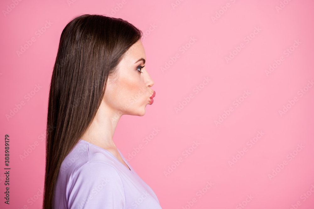 Closeup profile photo of attractive pretty lady long hairdo look side empty space charming appearance sending air kisses date wear casual violet t-shirt isolated pink pastel color background Closeup profile photo of attractive pretty lady long hairdo look side empty space charming appearance sending air kisses date wear casual violet t-shirt isolated pink pastel color background