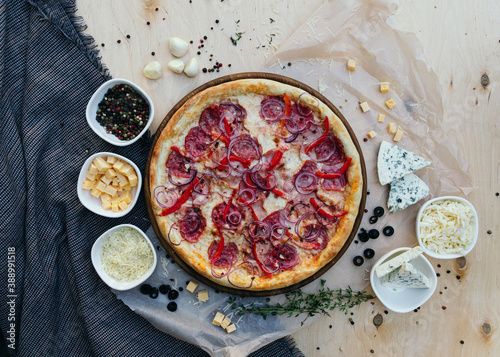 Tasty italian pizza made from an authentic recipe. Mozzarella topping mealted on top. Sauce aside. Professional product photography. photo