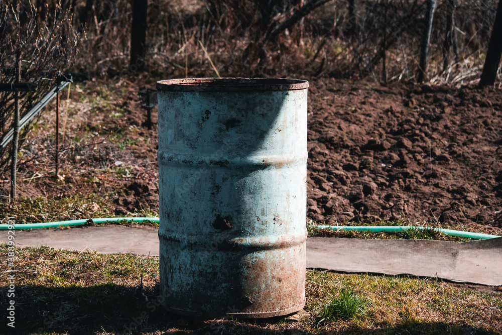 Old wooden barrel standing in a corner of an old house to collect water Old wooden barrel standing in a corner of an old house to collect water
