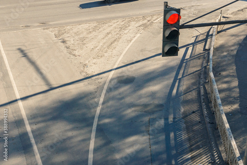 red traffic light above the roadway from above