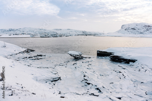 the coast of the Bay swept by snow on a frosty winter day in the far North