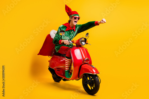 Bild auf Leinwand Portrait of his he nice attractive cheerful energetic funny guy elf riding moped