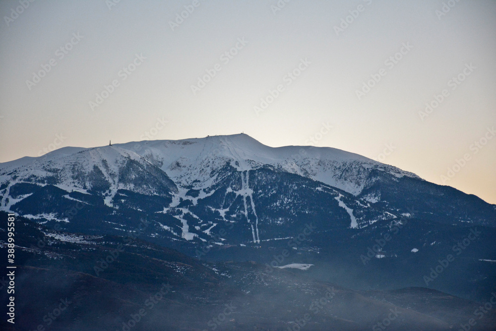 Ski resort seen from afar on a beautiful mountain at sunset time