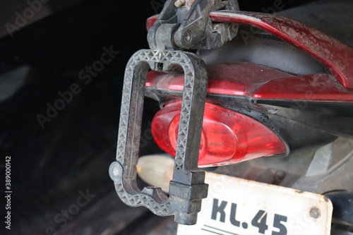 Old Helmet holder fixed on Honda motorcycle grab rail