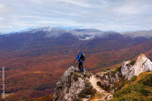 Mountain hiker in autumn landscape.