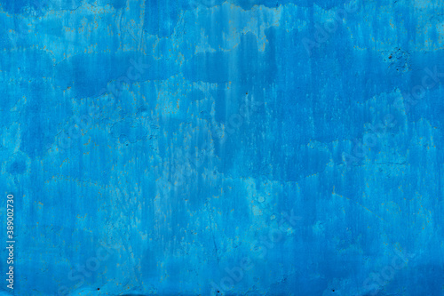 Old sheet metal covered with blue paint. There are screw holes, paint drips and small spots of corrosion. Background. Texture.