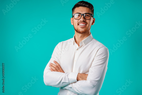 Portrait of a young mixed race businessman against blue background