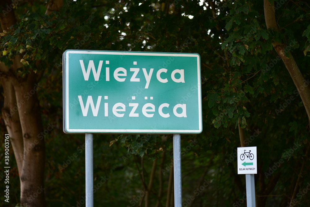 Wiezyca village road information sign in Kashubian language. Endangered language in the UNESCO list. Wiezyca village road information sign in Kashubian language. Endangered language in the UNESCO list.