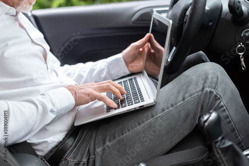 Businessman using his laptop in car © thodonal