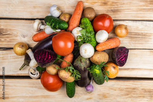 Assortment of fresh vegetables on wood background