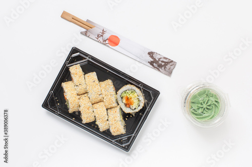 Food delivery concept, sushi in plastic container delivered to home