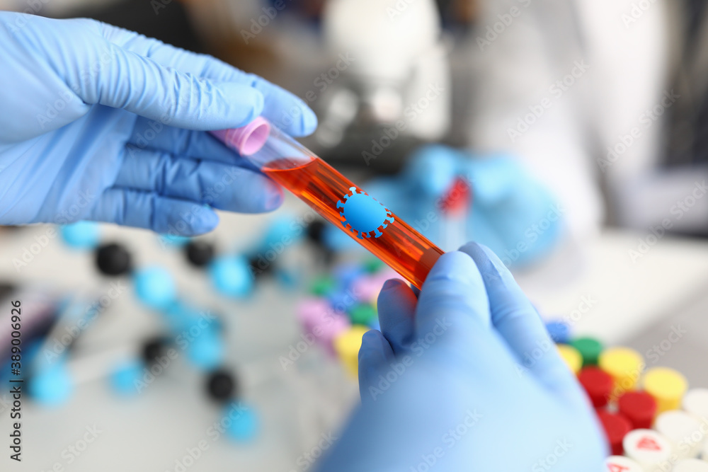 Hands in rubber gloves hold test tube with blood infected with coronavirus in biological laboratory closeup. Development of vaccine against covid 19 concept. Hands in rubber gloves hold test tube with blood infected with coronavirus in biological laboratory closeup. Development of vaccine against covid 19 concept.