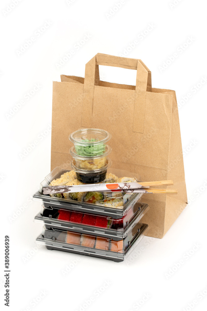Fototapeta premium Food delivery concept, sushi in plastic container delivered to home