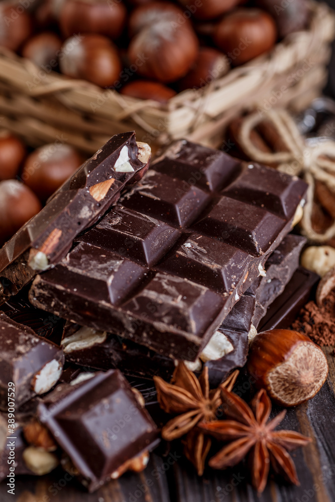 Stack of chocolate slices with mint leaf on a wooden table.Assortment of fine chocolates in white, dark, and milk chocolate. Sweet food photo concept. Stack of chocolate slices with mint leaf on a wooden table.Assortment of fine chocolates in white, dark, and milk chocolate. Sweet food photo concept.