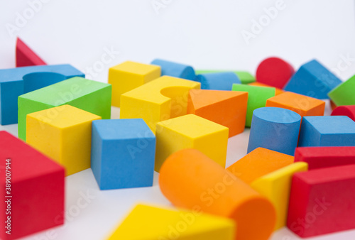 Bright multi-colored details of the designer. Children's toy on a white background. Background of colorful toy figures.