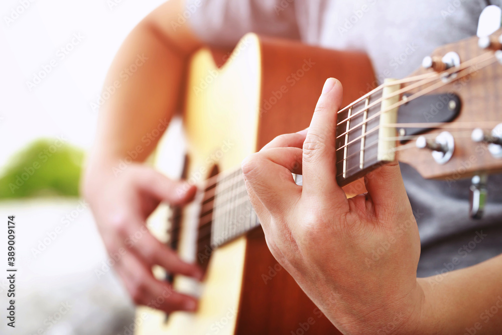 Fototapeta premium Stylish Acoustic Guitar Playing by hand. Artist musician in public park.