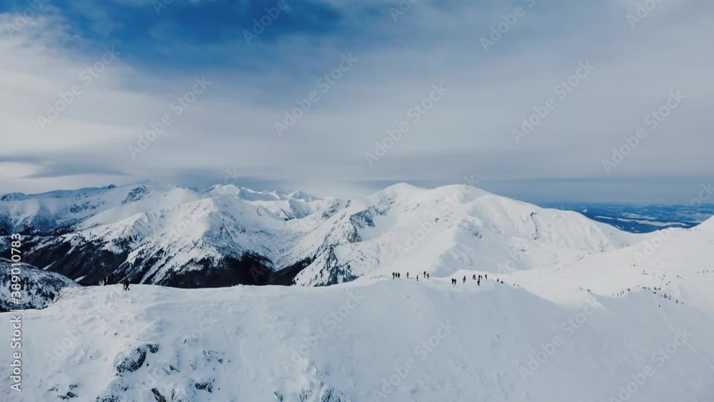 Aerial view of snow mountain range landscape in Zakopane under blue sky with winding road and sea of clouds in the background 4k winter drone Aerial view of snow mountain range landscape in Zakopane under blue sky with winding road and sea of clouds in the background 4k winter drone