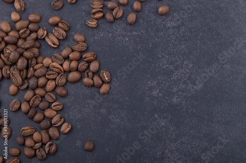 Brown coffee bean isolated on dark background.