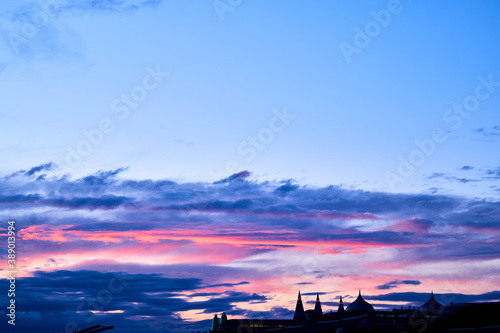 Beautiful dramatic pink and blue clouds in sky during sunset