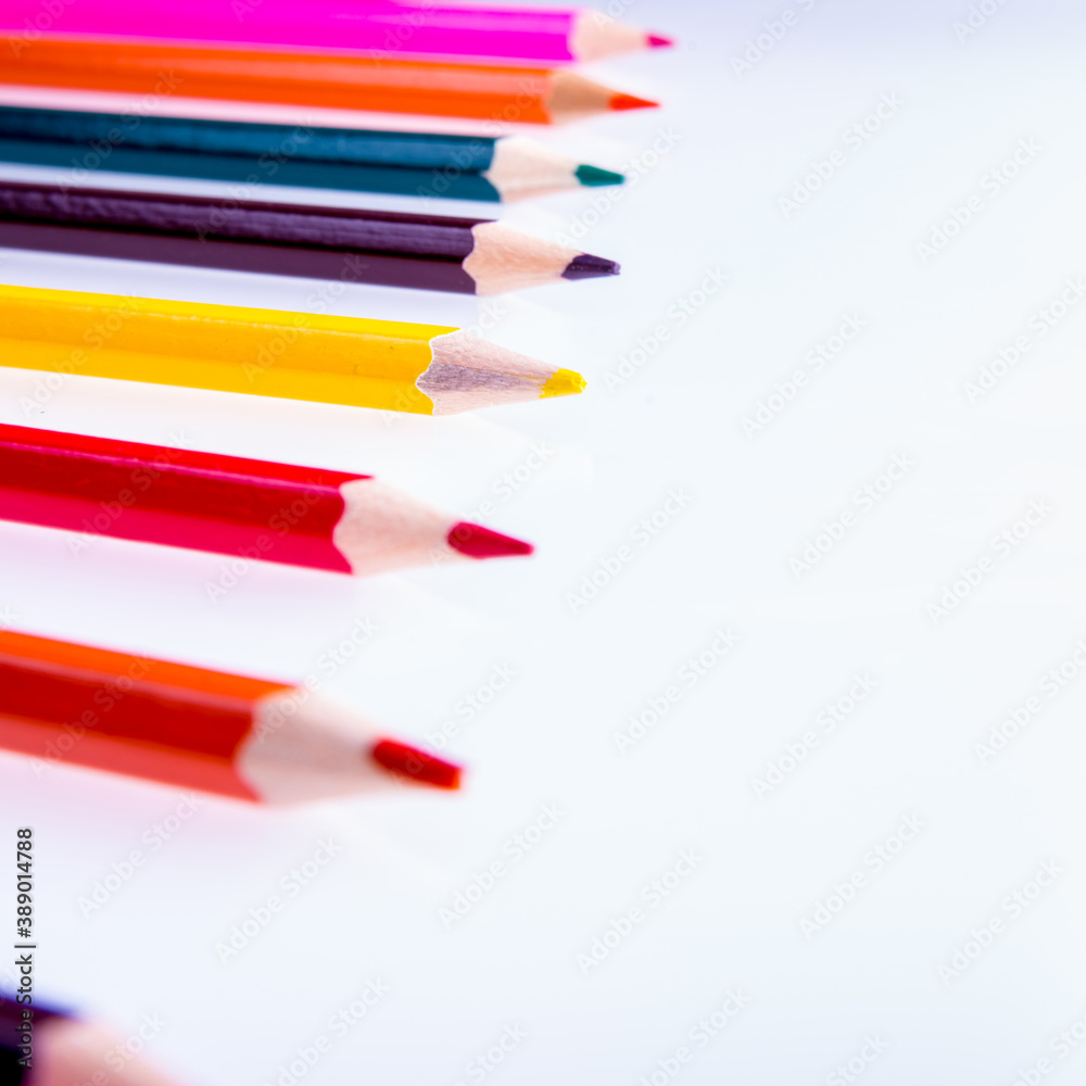 Colored pencils on a white background, copy space, isolated, close-up, side view Colored pencils on a white background, copy space, isolated, close-up, side view