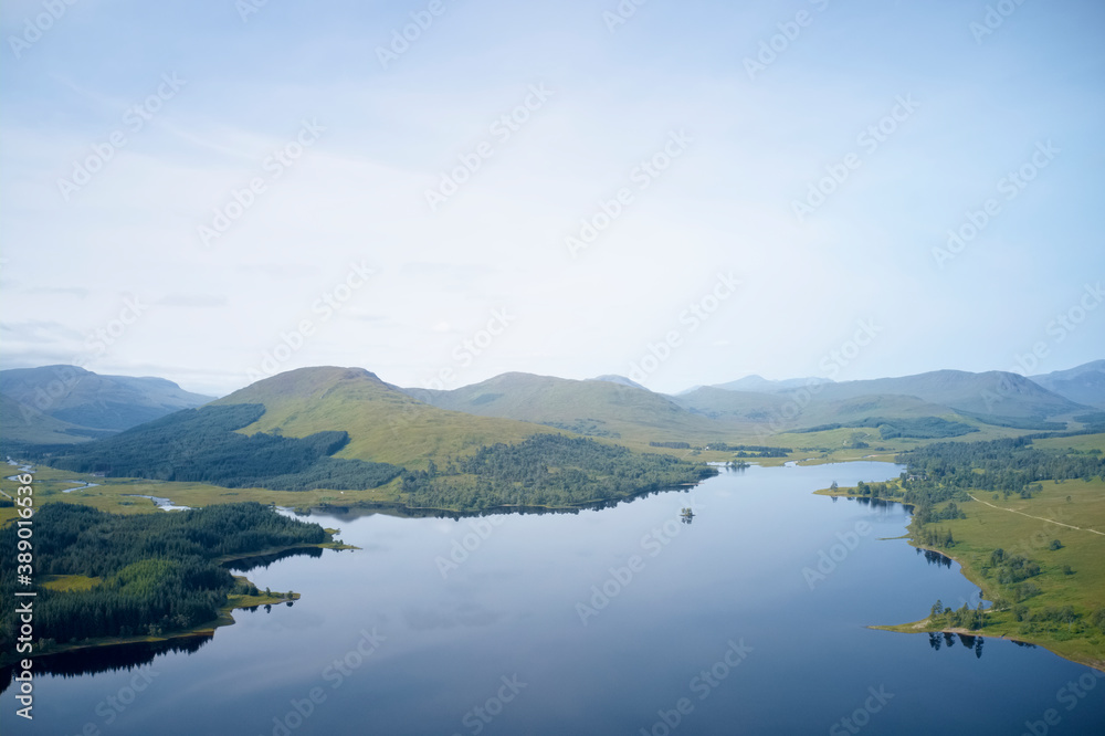 Mindfulness calm background banner of aerial view from above loch at sunrise in Scotland