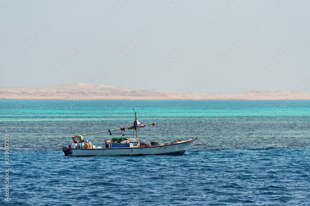 Motor fishing boat in the blue sea
