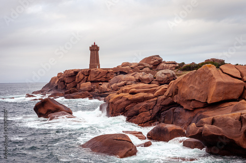 Ploumanac'h  pink granite Coast in Brittany with view on lighthouse, horizontal