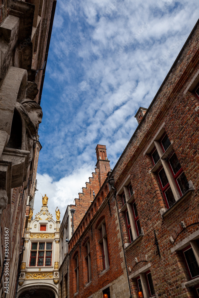 Brugge upward diagonal view of old buildings and cloudy blue sky