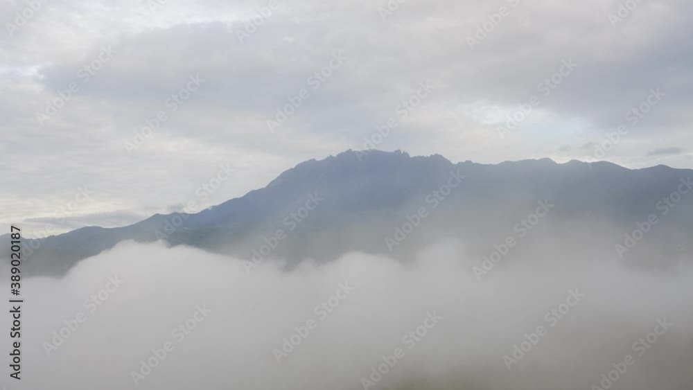 Time lapse MOUNT KINABALU foggy or the clouds while sunrise sky. Sea of clouds. Foggy valley mount ridge nature. Taken At RANAU, SABAH, BORNEO , MALAYSIA. time lapse motion zoom out Time lapse MOUNT KINABALU foggy or the clouds while sunrise sky. Sea of clouds. Foggy valley mount ridge nature. Taken At RANAU, SABAH, BORNEO , MALAYSIA. time lapse motion zoom out