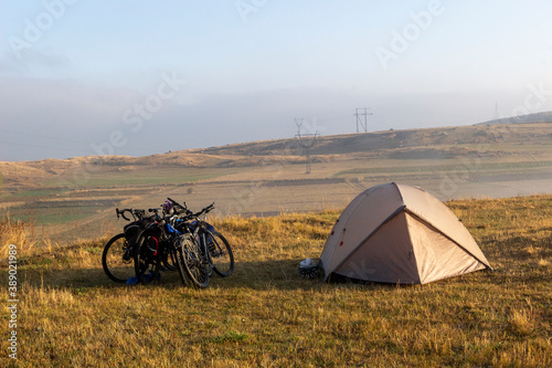 camping with bicycles and a tent near the mountains in summer