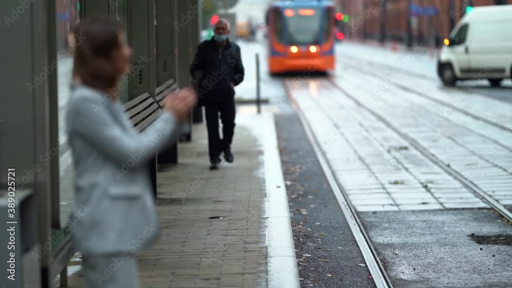 custom made wallpaper toronto digitalwoman with cervical collar for curing osteochondrosis is standing on tram station in city, checking app in mobile phone