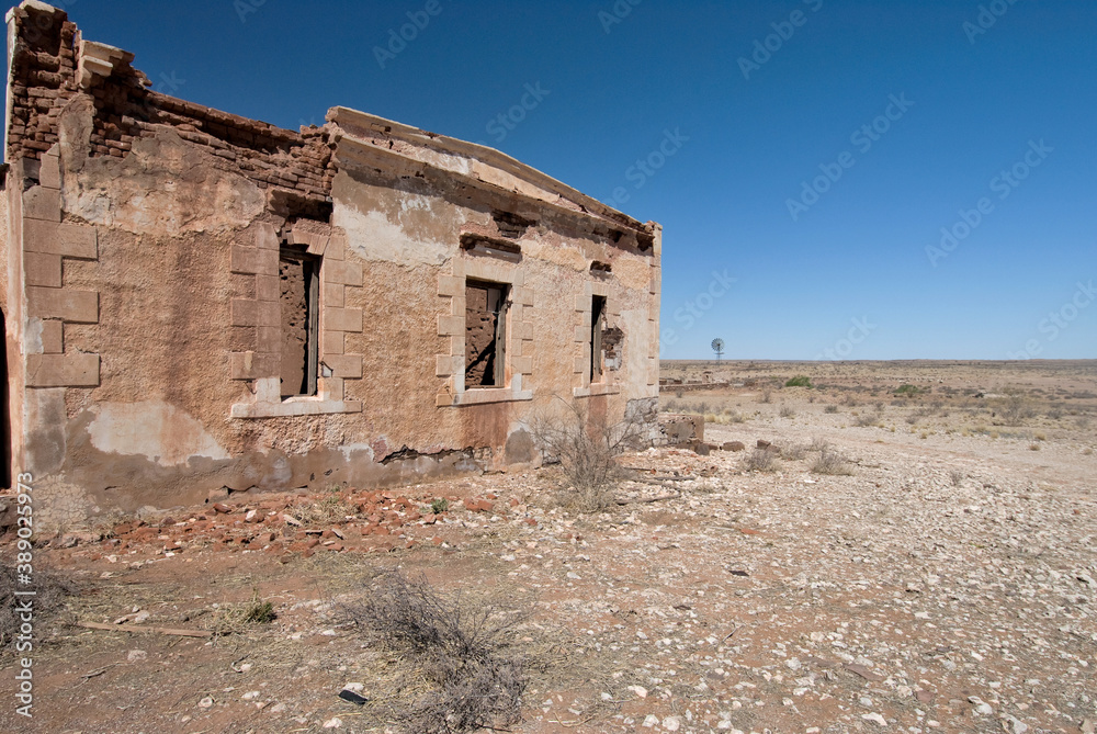 A ruined and forgotten farm house in the Kalahari against in the blue sky