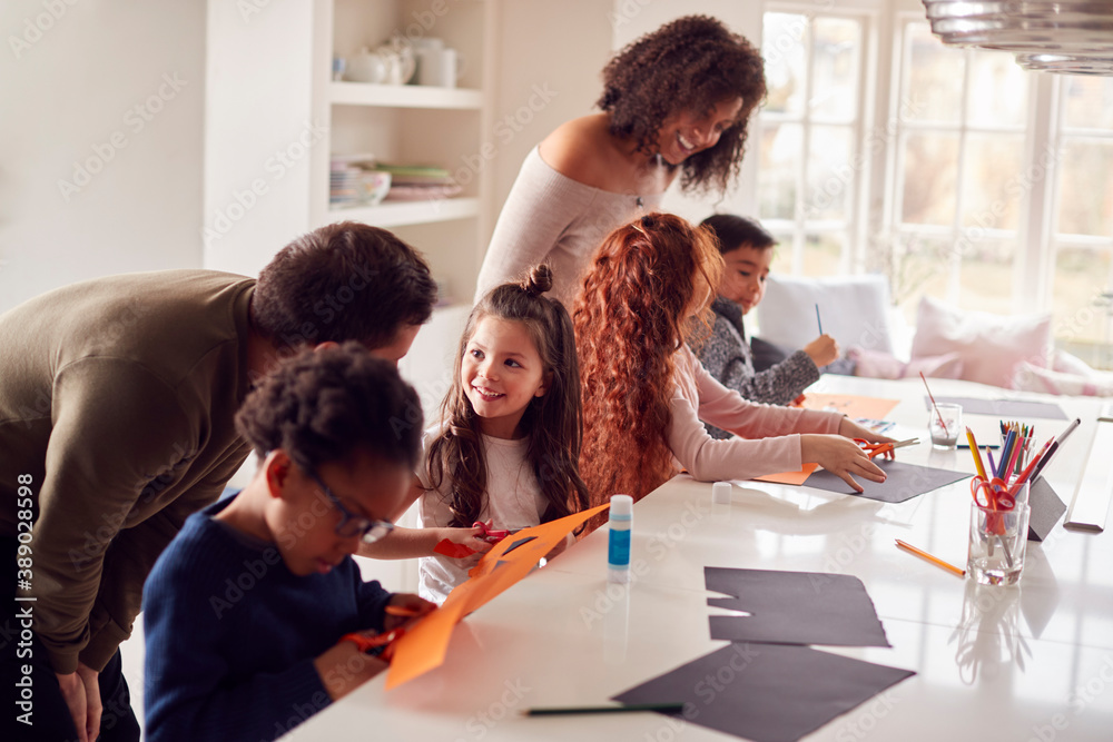 Obraz premium Group Of Children At Home With Parents Having Fun Making Craft Together