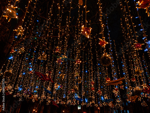 Winter glowing street christmas decorations.  Christmas garlands on a dark background