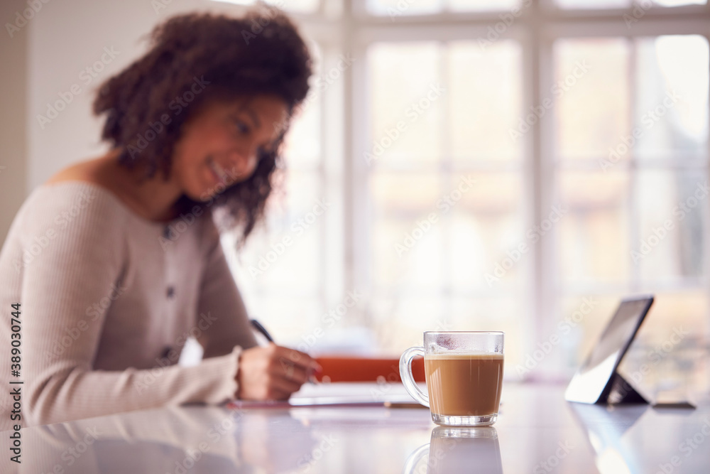 Woman With Digital Tablet Working From Home On Kitchen Counter Woman With Digital Tablet Working From Home On Kitchen Counter