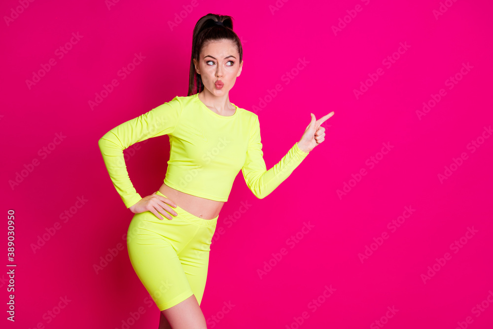 Photo of young sportswoman lips plump point index finger copyspace isolated over pink shine color background Photo of young sportswoman lips plump point index finger copyspace isolated over pink shine color background