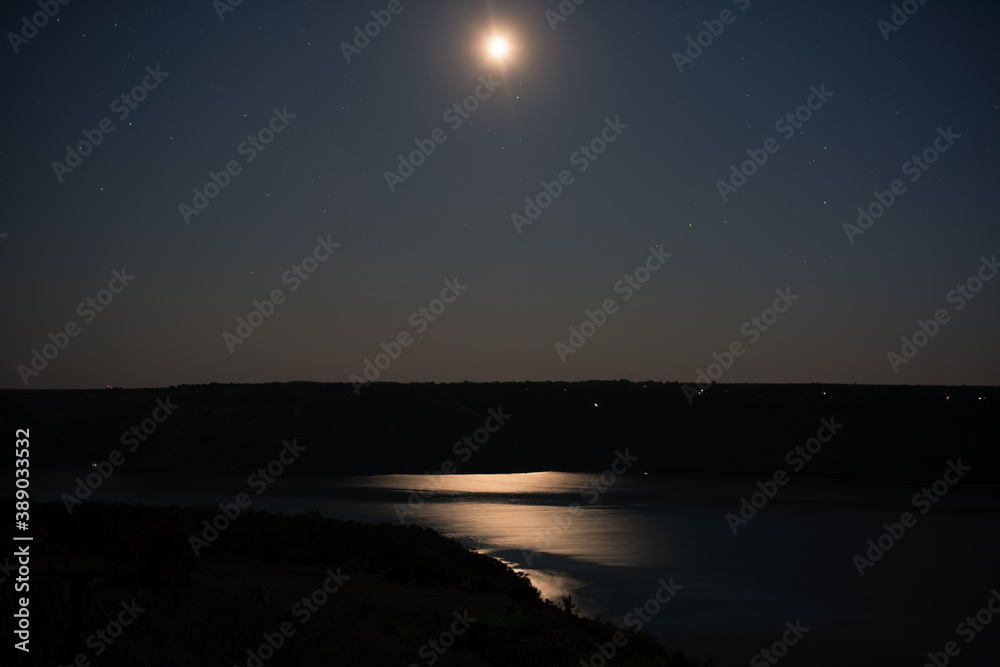 long exposure night photograph of the starry sky, moon and river long exposure night photograph of the starry sky, moon and river
