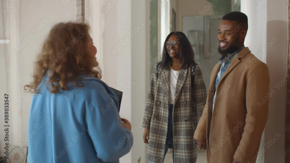 Real estate agent selling apartment to young african family Real estate agent selling apartment to young african family