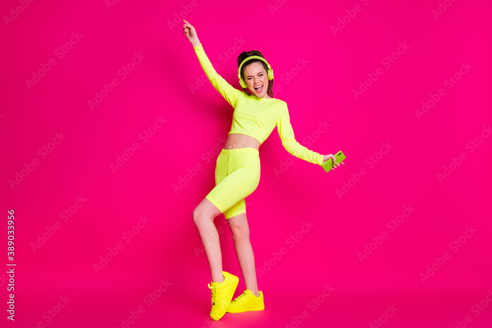 Full length body size view of her she nice attractive thin cheerful cheery glad girl listening music pop dancing having fun rest relax isolated bright vivid shine vibrant pink fuchsia color background Full length body size view of her she nice attractive thin cheerful cheery glad girl listening music pop dancing having fun rest relax isolated bright vivid shine vibrant pink fuchsia color background