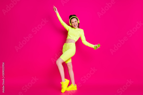 Full length body size view of her she nice attractive thin cheerful cheery glad girl listening music pop dancing having fun rest relax isolated bright vivid shine vibrant pink fuchsia color background
