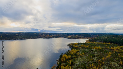 Northern nature landscape  Lake Ladoga in autumn in sunny weather with cloudy blue sky