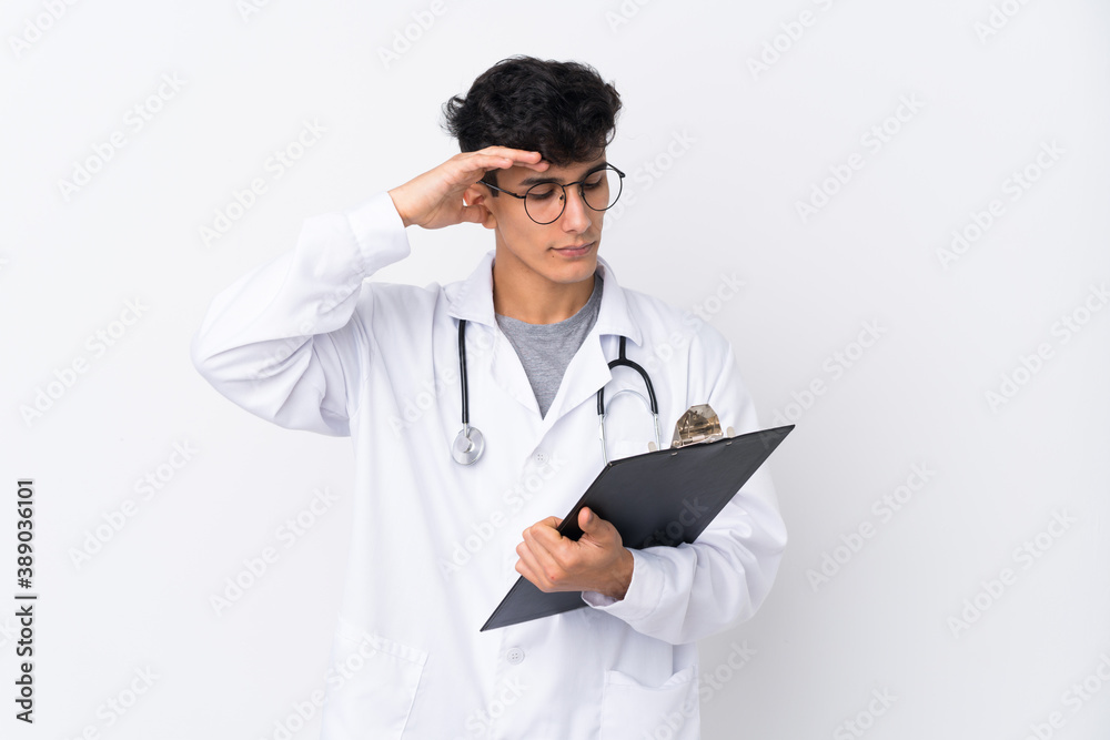 Young Argentinian man over isolated white background wearing a doctor gown and holding a folder Young Argentinian man over isolated white background wearing a doctor gown and holding a folder