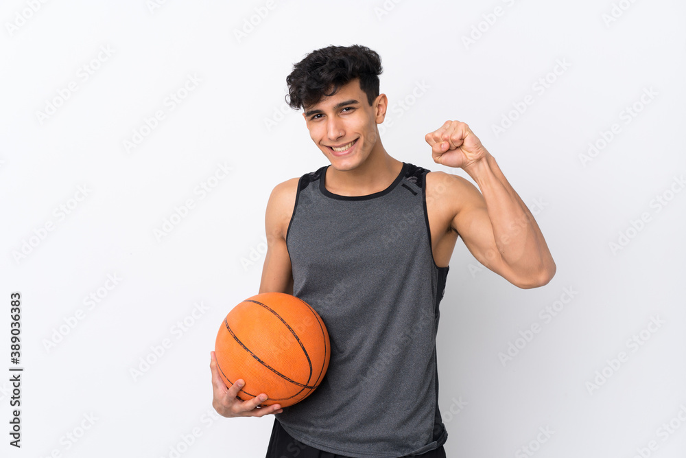 Obraz premium Young Argentinian man over isolated white background playing basketball and proud of himself