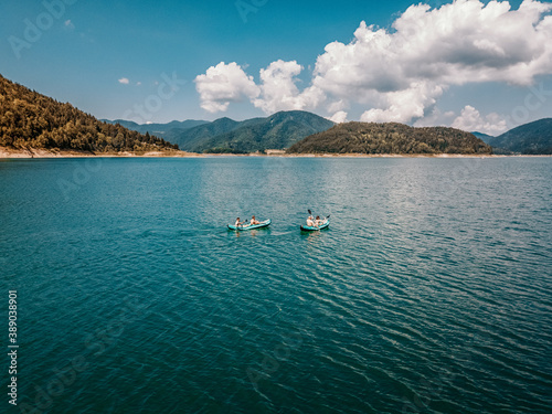 Two couples kayaking in Zaovine lake in Tara mountain region, Serbia