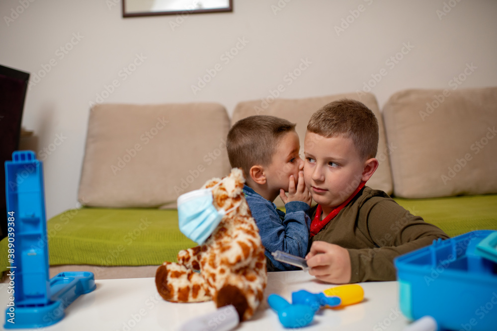 Children at home quarantine checking stuffed toy, for protection against viruses during coronavirus COVID-19 and flu outbreak. Children and illness disease concept. Children at home quarantine checking stuffed toy, for protection against viruses during coronavirus COVID-19 and flu outbreak. Children and illness disease concept.