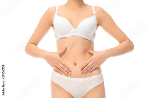 Beautiful female belly and chest isolated on white background. Beauty, cosmetics, spa, depilation, treatment and health concept. Fit and sportive, sensual body with well-kept skin in towel.